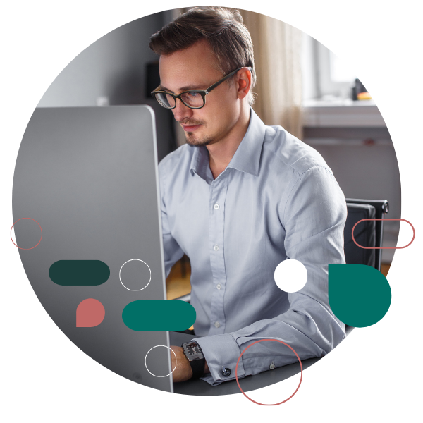 Male tech worker coding at her desk